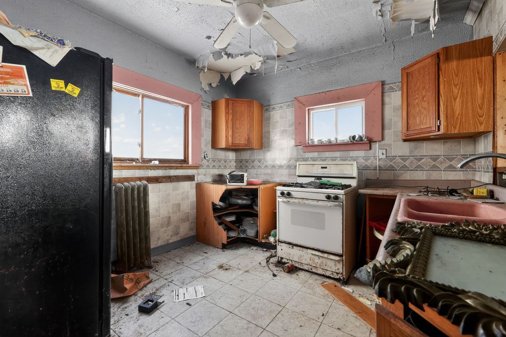 Water damage on ceiling and walls of living room in Detroit Michigan bank-owned property — condition documentation by RealtyPix