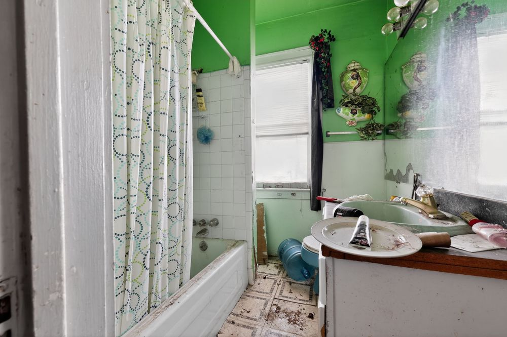 Water damage on ceiling and walls of living room in Detroit Michigan bank-owned property — condition documentation by RealtyPix