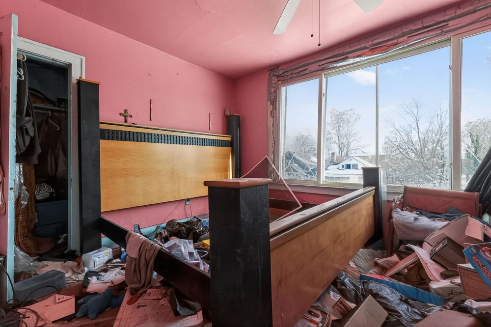 Water damage on ceiling and walls of living room in Detroit Michigan bank-owned property — condition documentation by RealtyPix