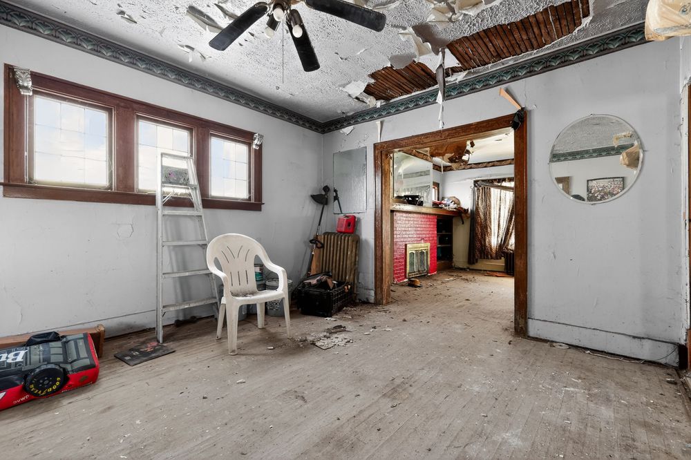 Water damage on ceiling and walls of living room in Detroit Michigan bank-owned property — condition documentation by RealtyPix