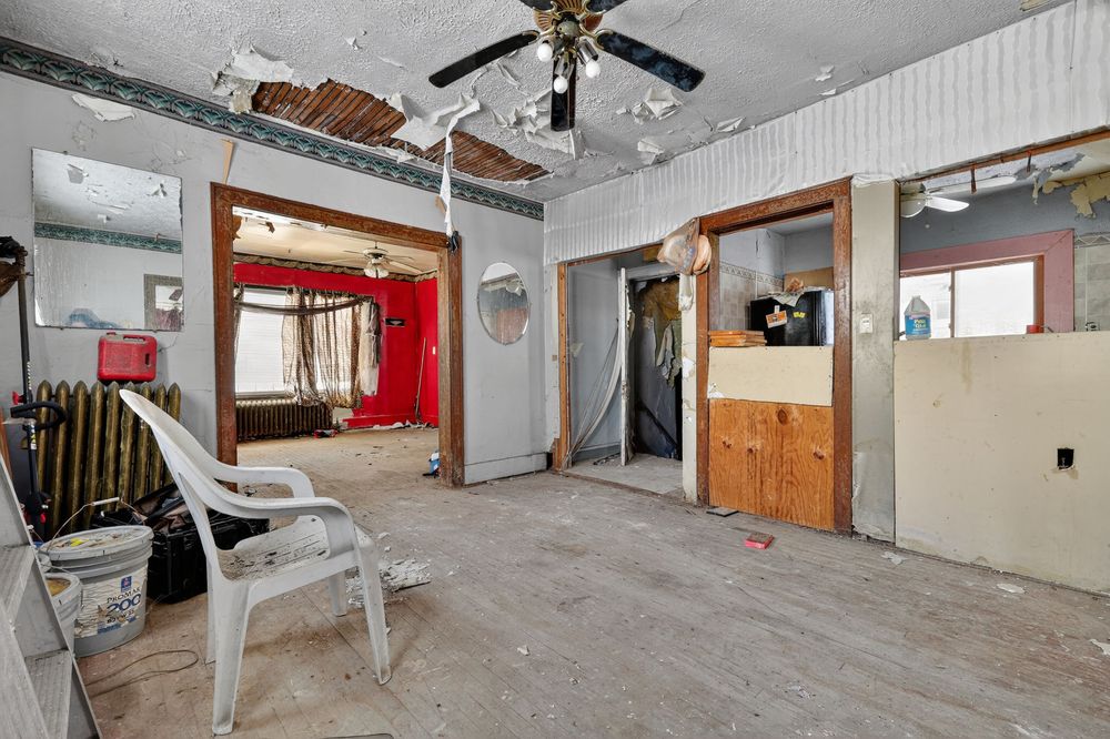 Water damage on ceiling and walls of living room in Detroit Michigan bank-owned property — condition documentation by RealtyPix