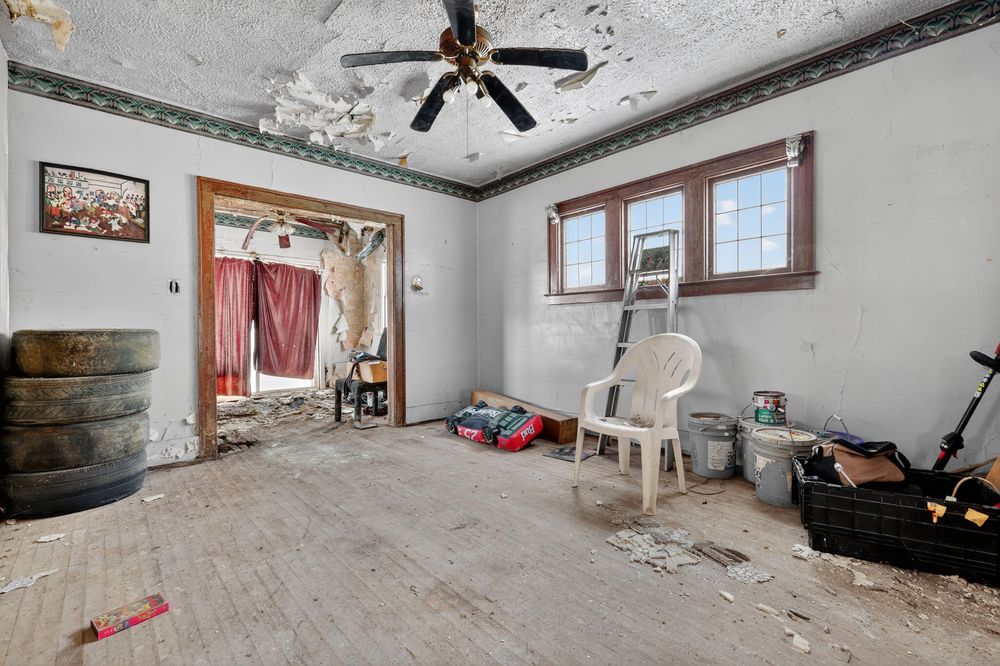 Water damage on ceiling and walls of living room in Detroit Michigan bank-owned property — condition documentation by RealtyPix