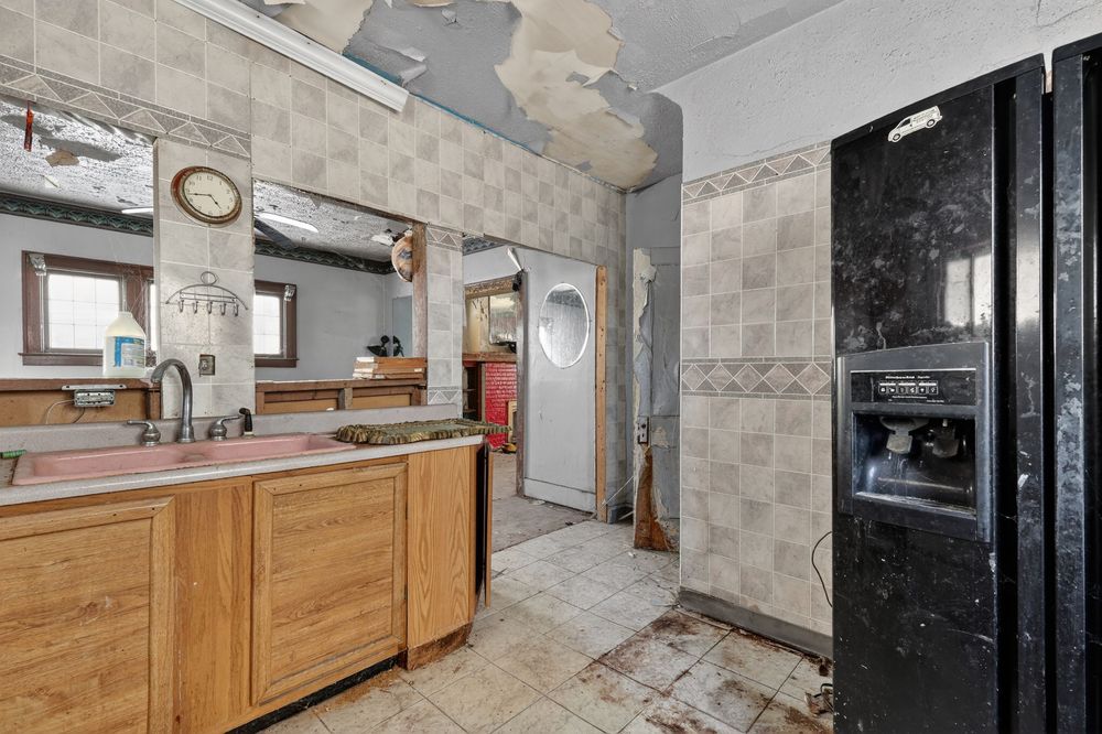 Water damage on ceiling and walls of living room in Detroit Michigan bank-owned property — condition documentation by RealtyPix