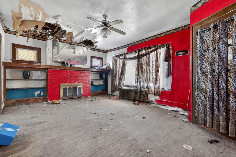 Water damage on ceiling and walls of living room in Detroit Michigan bank-owned property — condition documentation by RealtyPix