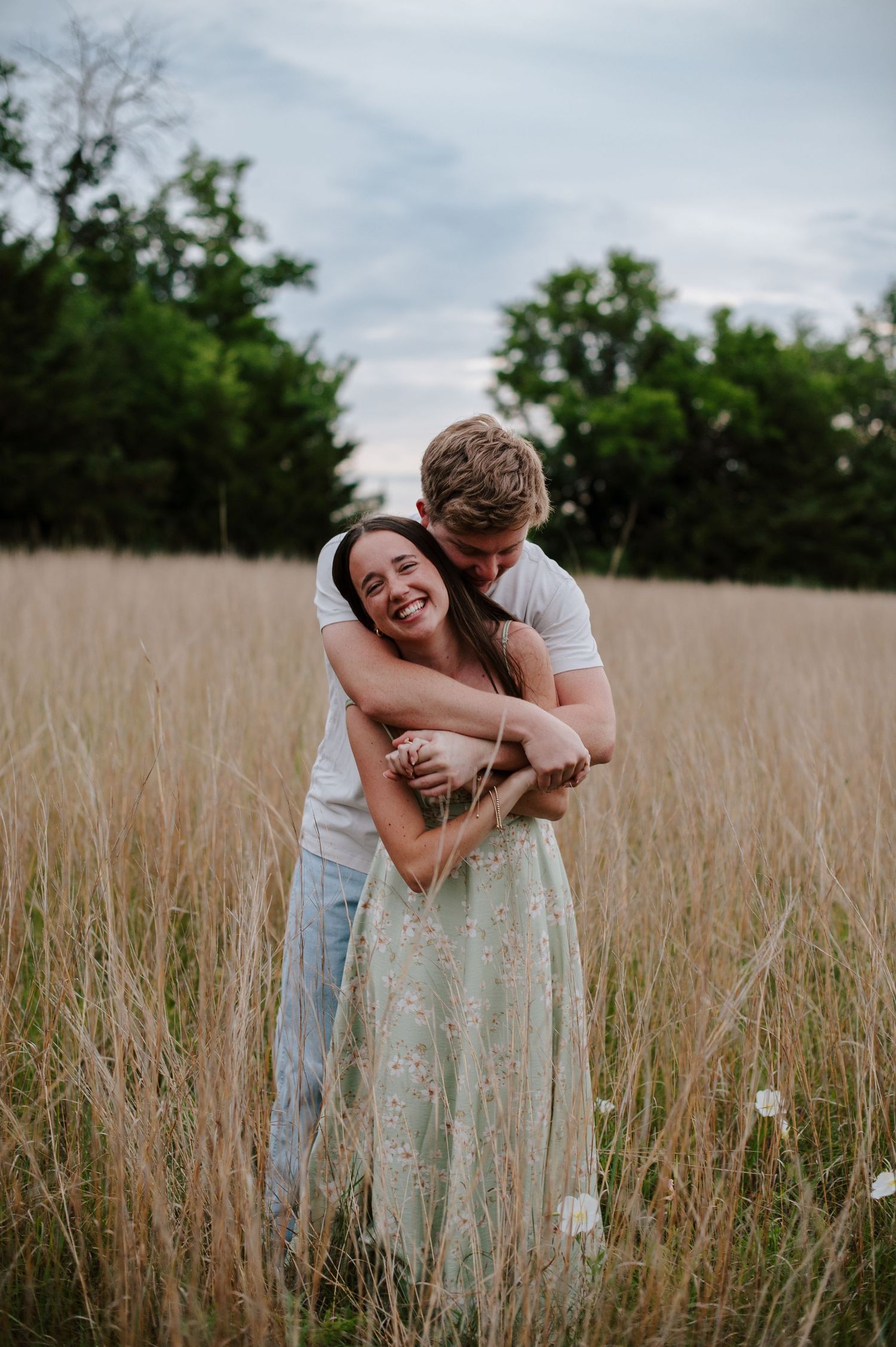 Wichita KS outdoor engagement photos in nature location Andover, couple photos in field with flowers, small elopement wedding photographer