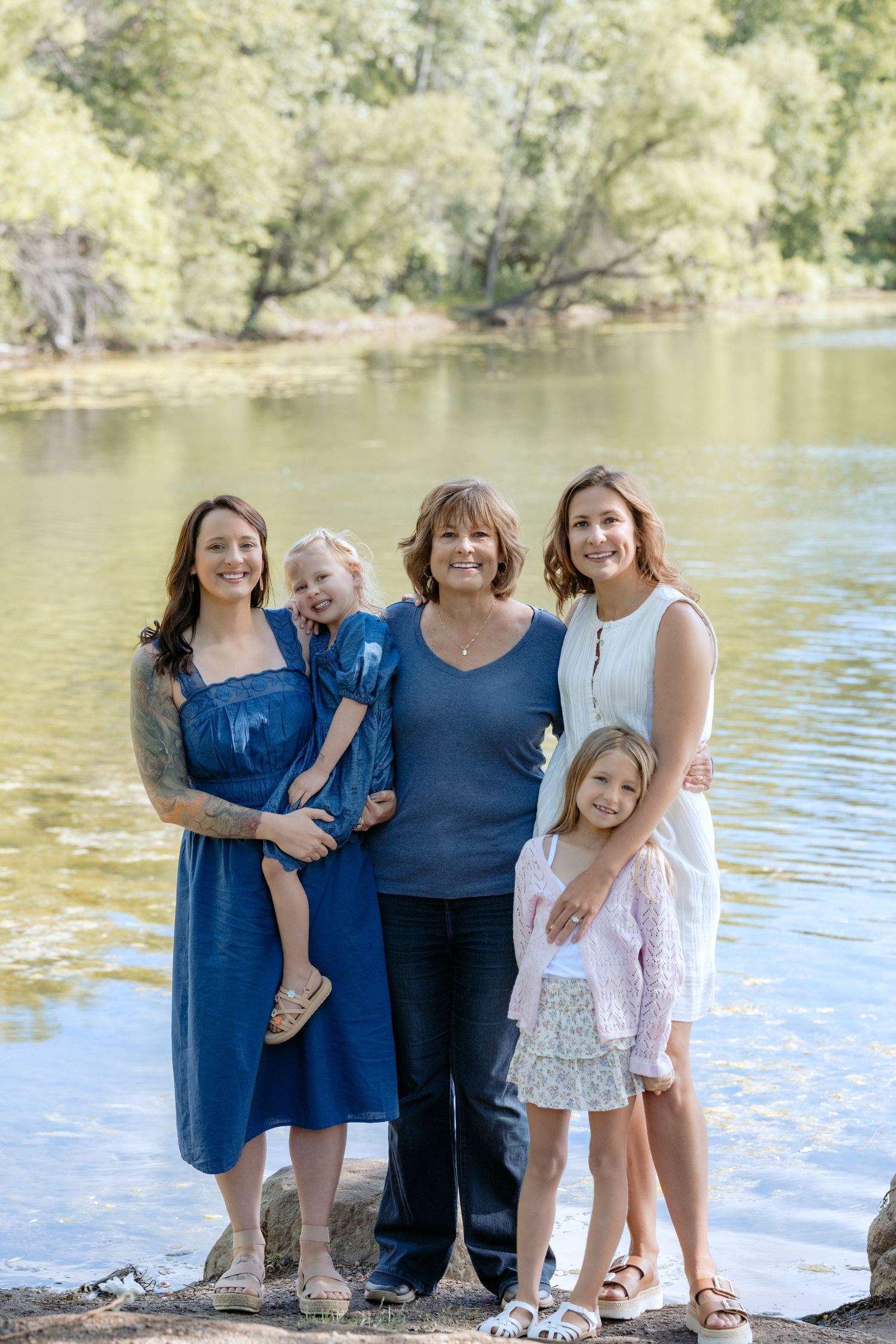 portrait of all the girls by the water during extended family portrait session at powers lake park in woodbury mn