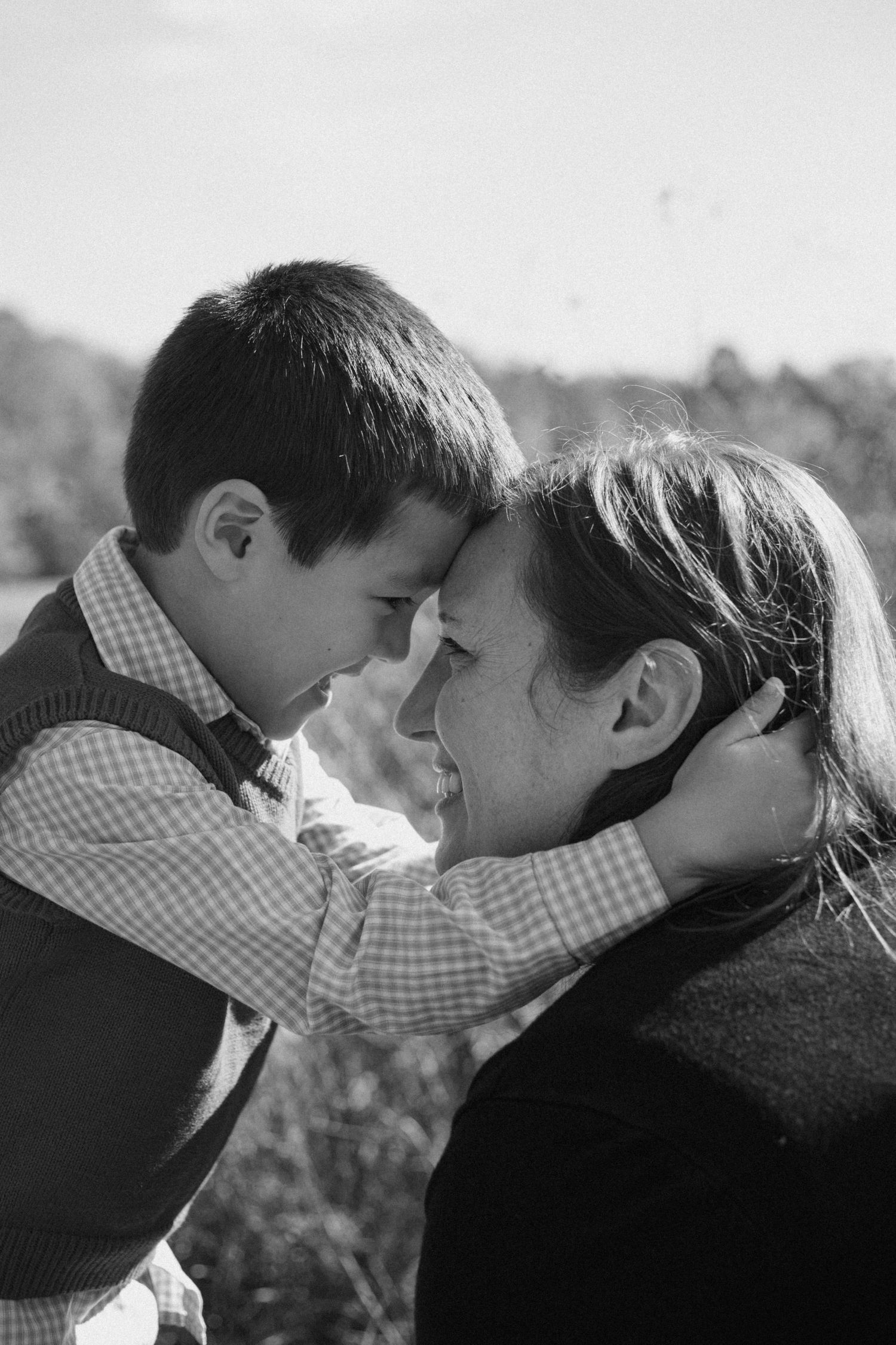A touching black and white portrait showing an intimate moment between parent and child.
