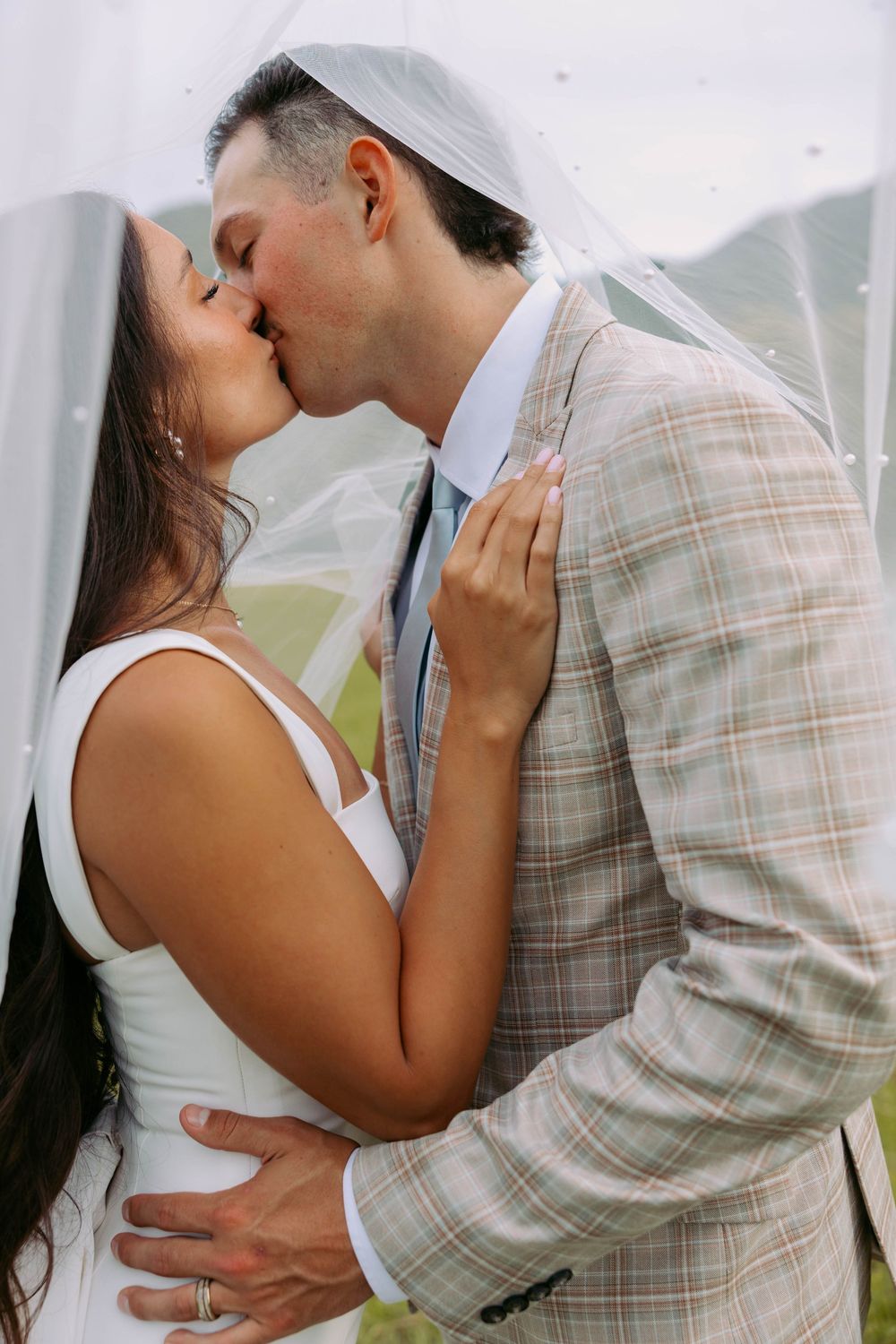 A romantic sequence showing couples embracing and kissing in formal attire against a light background.