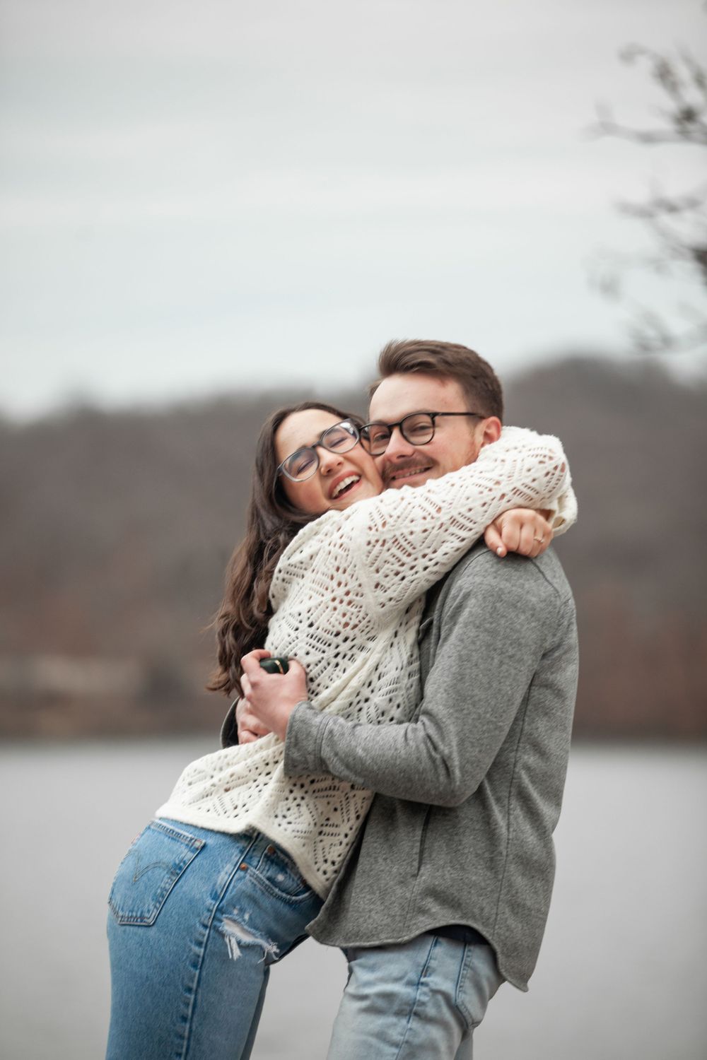 ©AnnaVonRiesenPhotography Engagement Portrait | Color image of a girl hugging her new fiance and smiling
