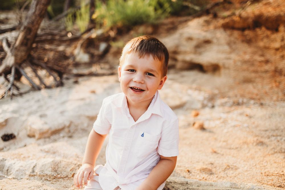 A cheerful expression captured against orange coastal cliffs.