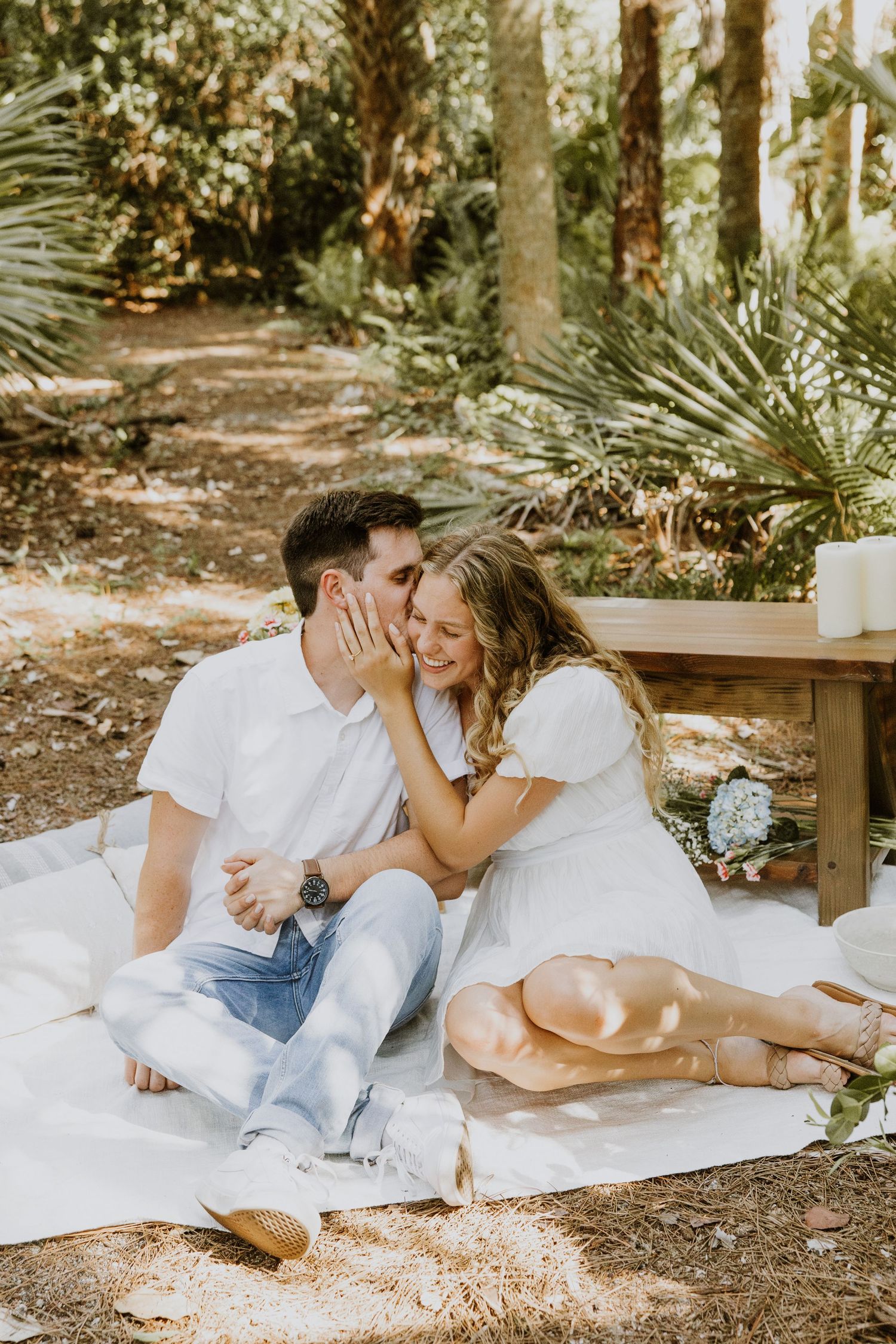 Woodsy proposal in West Palm Beach, Florida at a nature trail captured by Lindsay McDow Photography. Greenery, picnic proposal