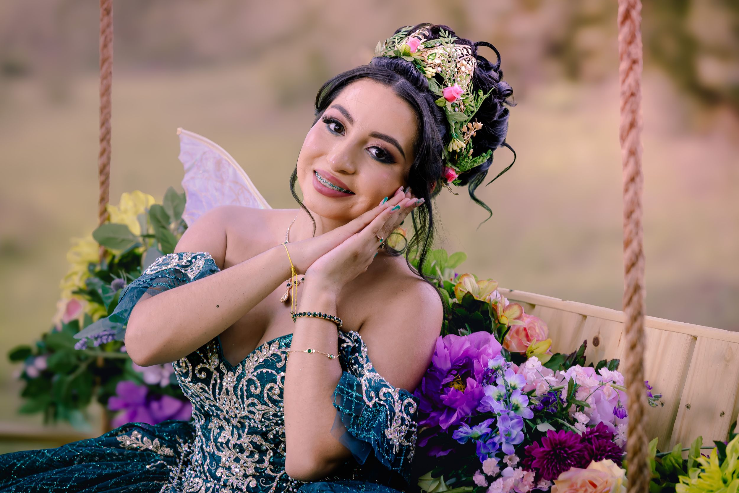 Whimsical garden photoshoot featuring colorful flowers and a decorative swing set.