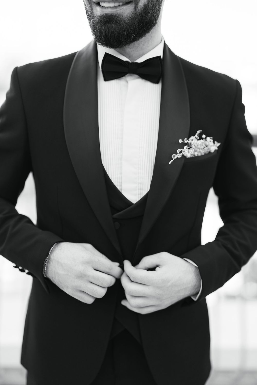 Close-up of formal black tuxedo with bow tie and pocket square.