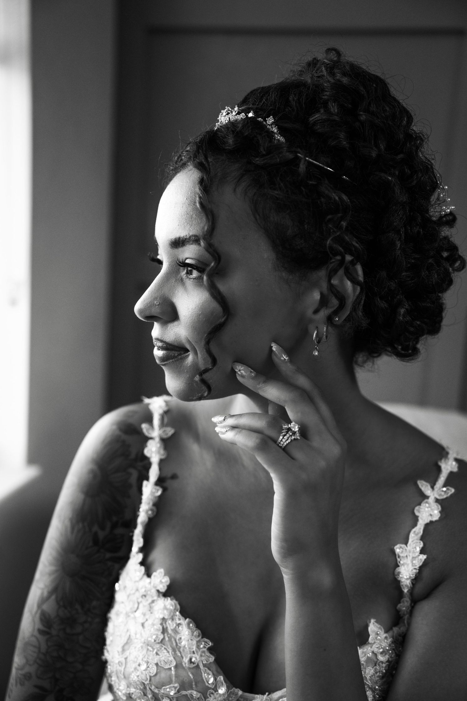 A sequence of four black and white profile portraits showing a person wearing a white dress with floral details looking to the side.