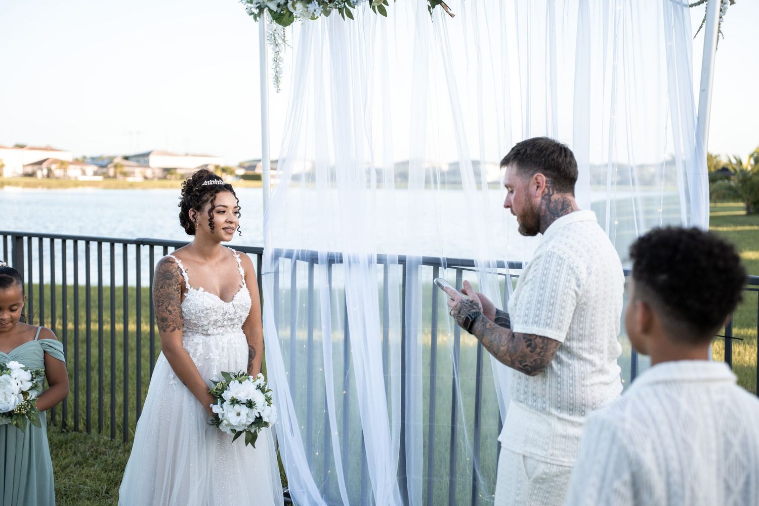 Five wedding photos in sequence show a couple dancing and embracing at a sunny outdoor waterfront venue.