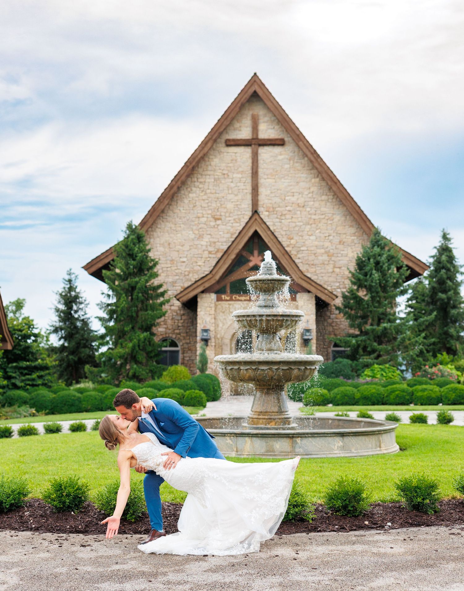 Scenic wedding ceremony setting overlooking a lake with white floral arrangements and elegant decor at Integrity Hills at Big Cedar Lodge.