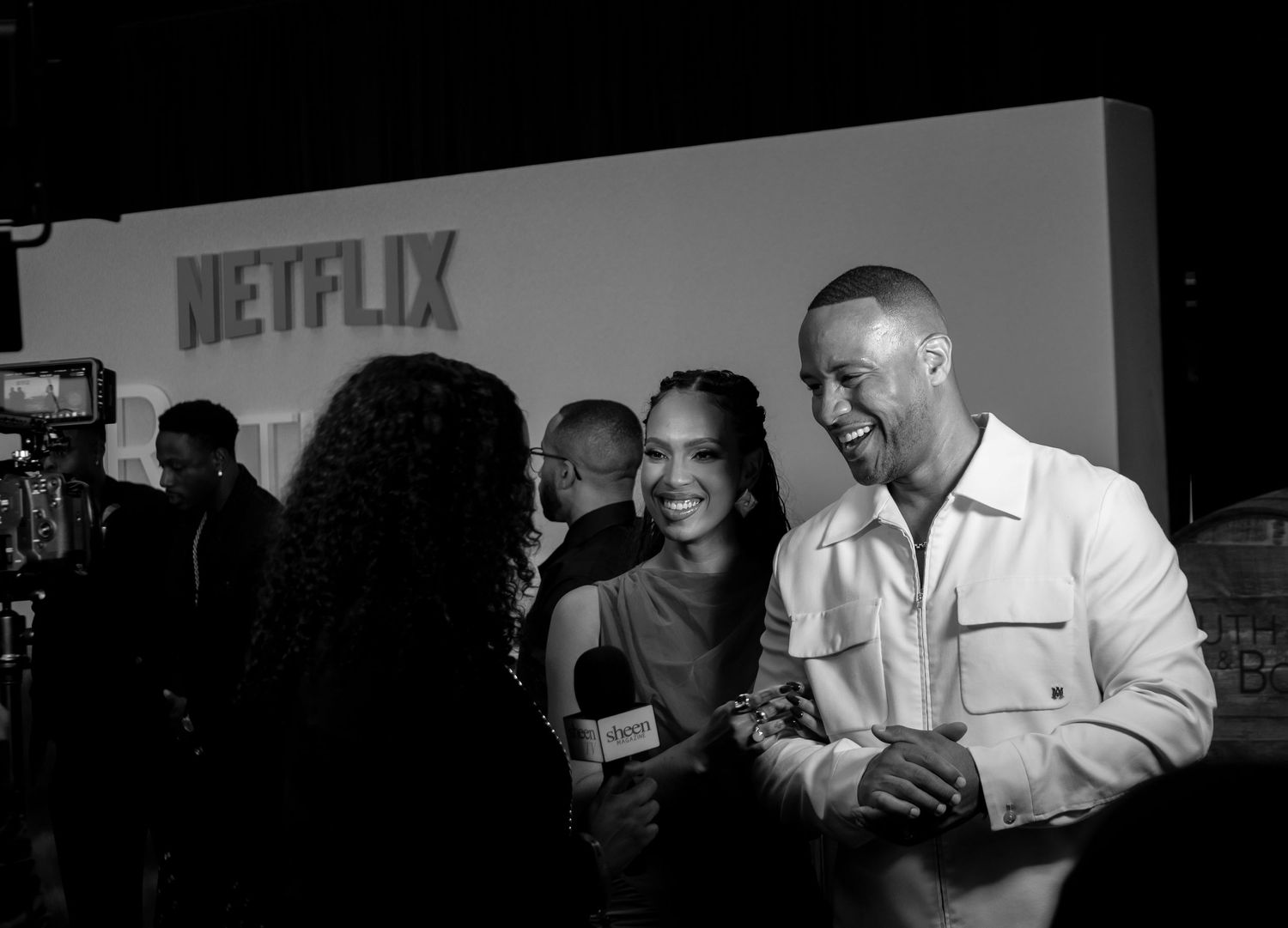 Black and white photo of Netflix event showing crowd interaction.