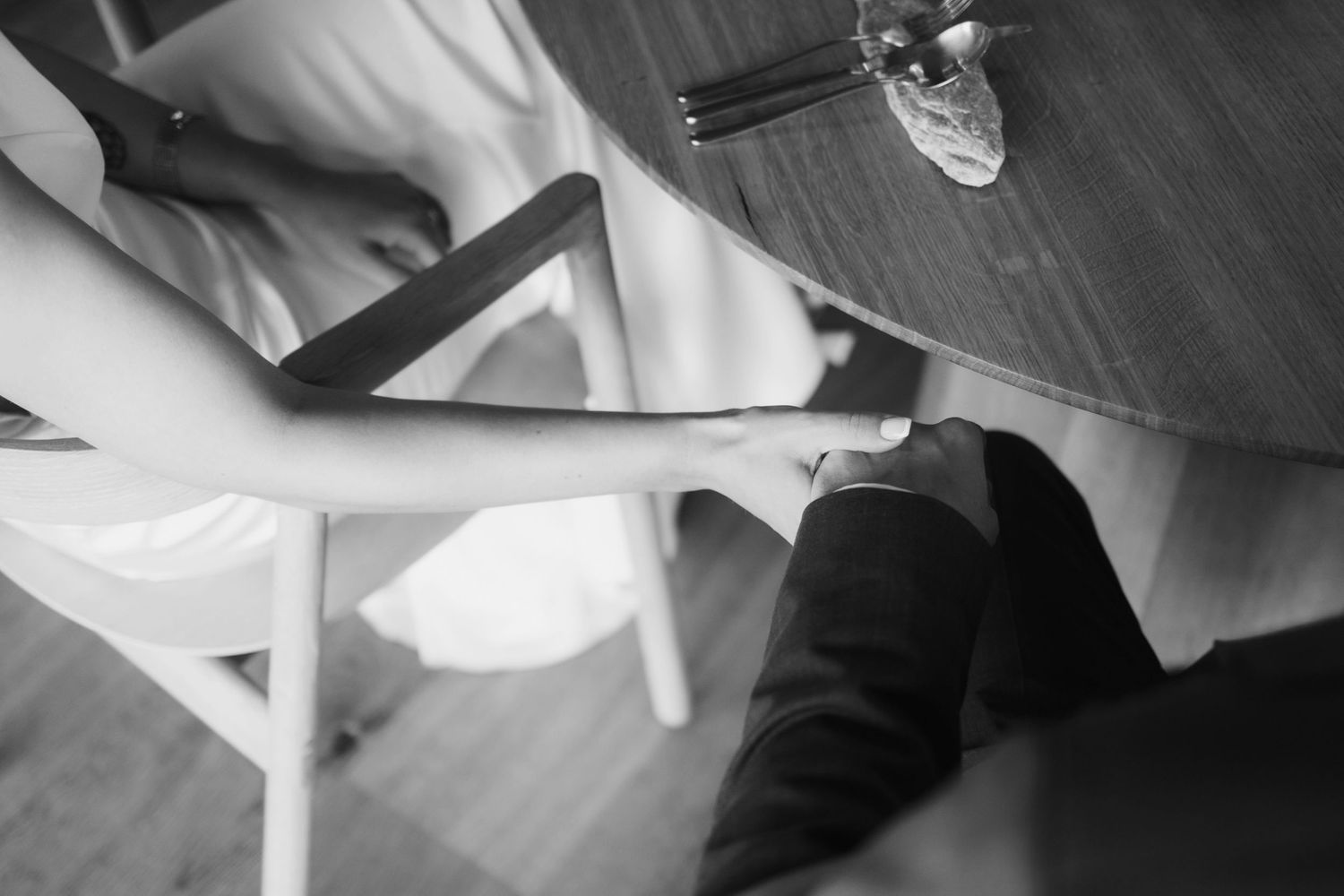 Black and white artistic detail shot of formal attire at a wedding event.