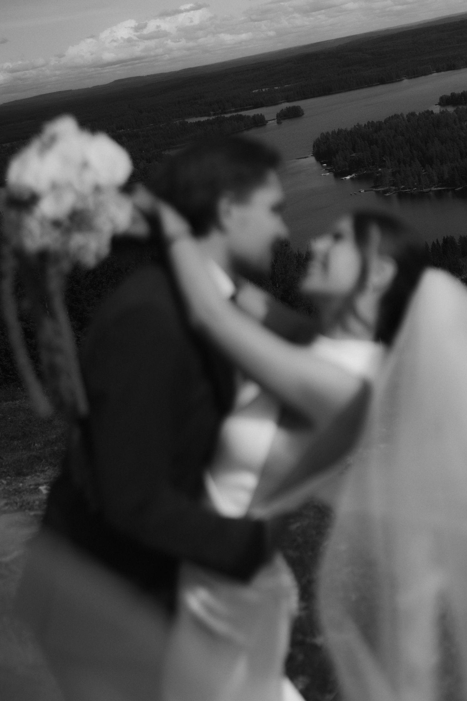 A wedding party silhouette against a scenic waterfront backdrop.