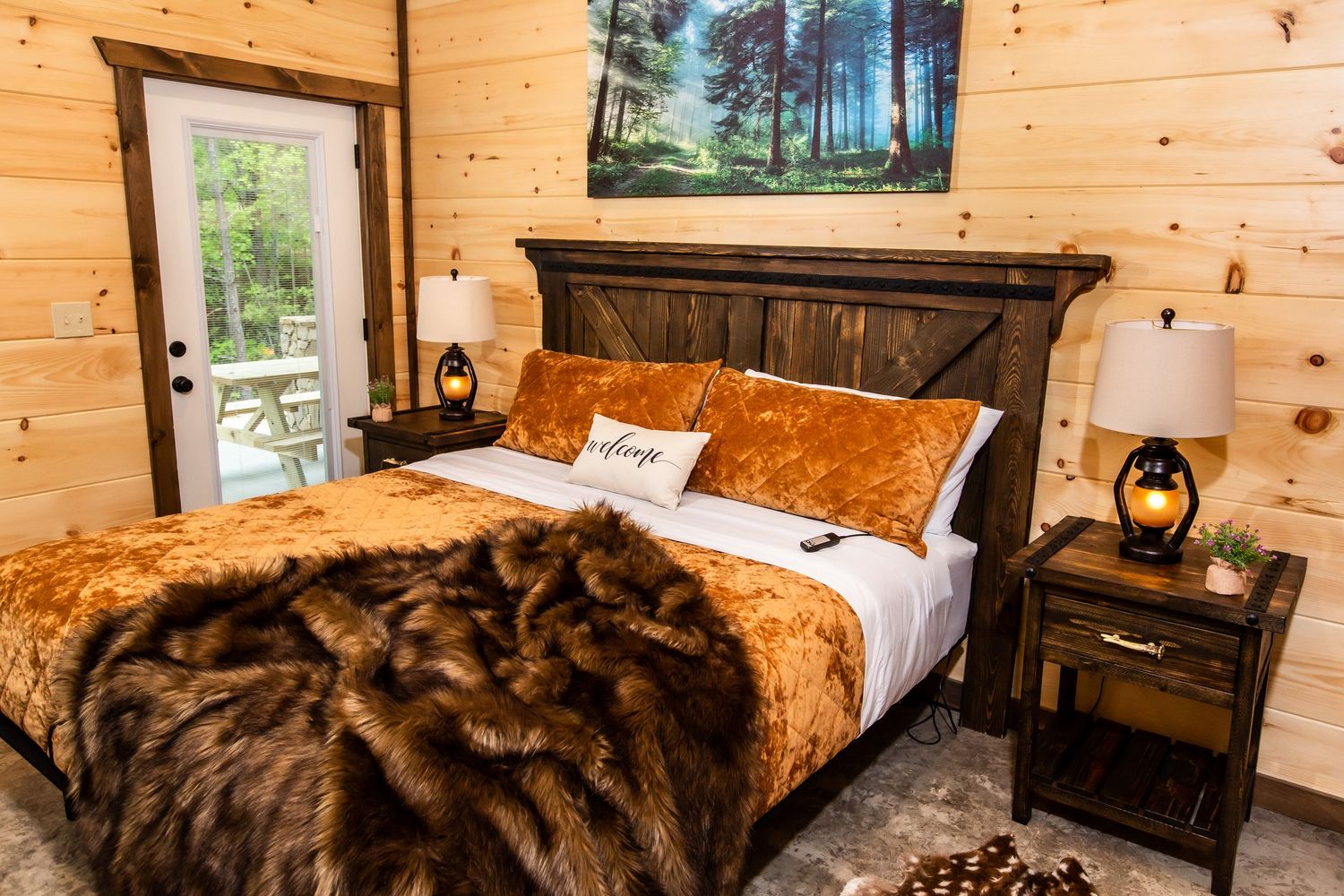 Luxurious brown fur throws and bedding in a cozy cabin bedroom with wooden walls.