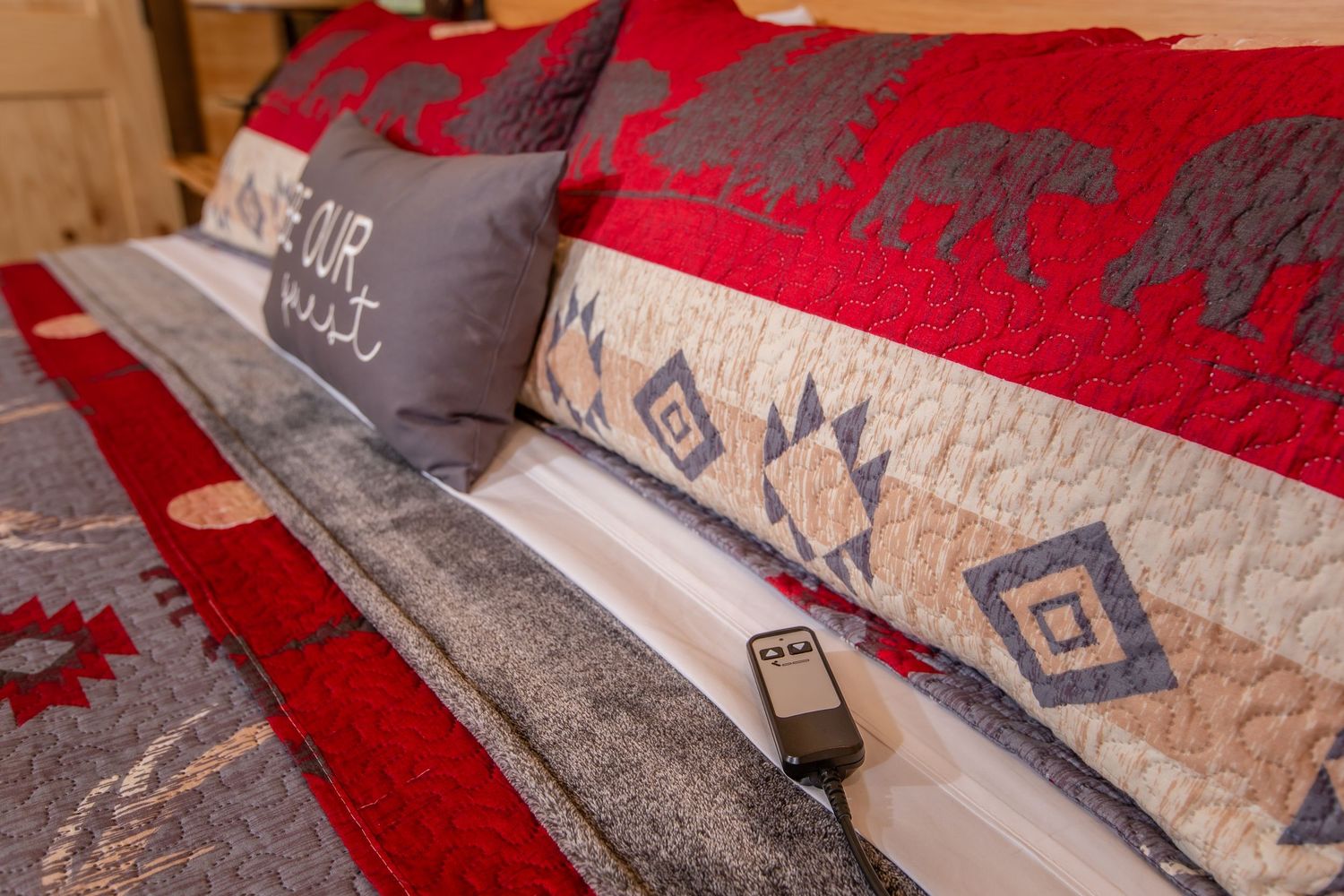 Red and beige decorative throw pillows with geometric patterns arranged on seating.