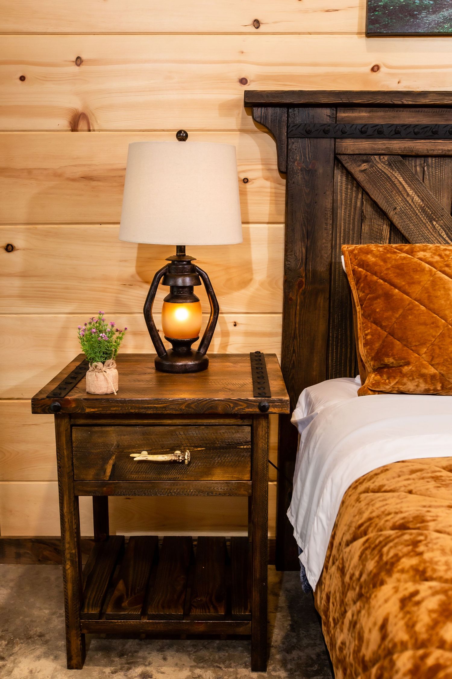 A series of rustic wooden nightstands with lamps displaying different angles and styling in a cozy cabin bedroom.