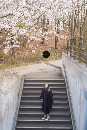 A series of concrete steps leading upward through a wooded area with fall foliage.
