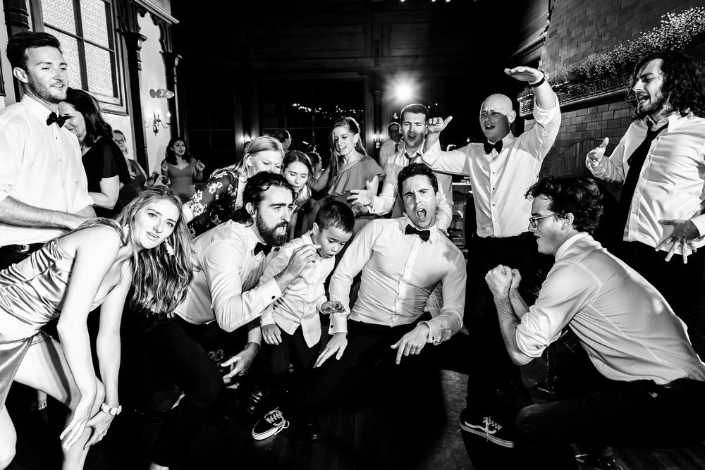 A series of candid black and white photos showing dancers enjoying themselves at a nightclub party. RI Wedding Photographer