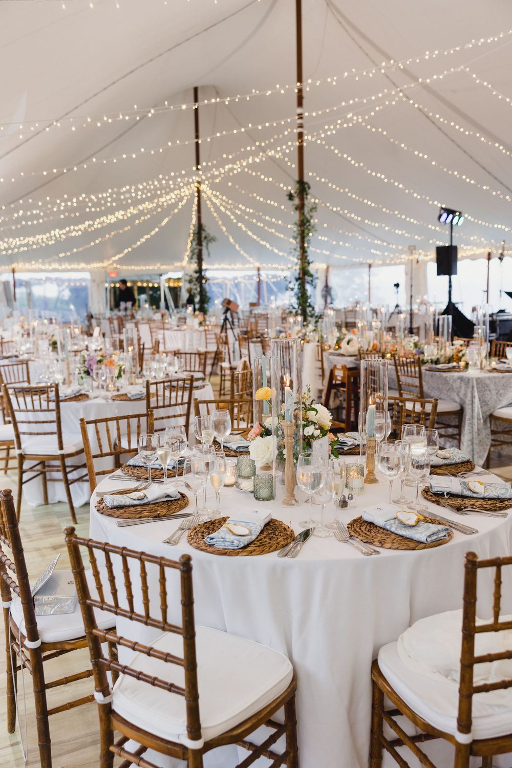 Elegant wedding reception setup under white tent with twinkling lights, round tables Mount Hope farm wedding photos