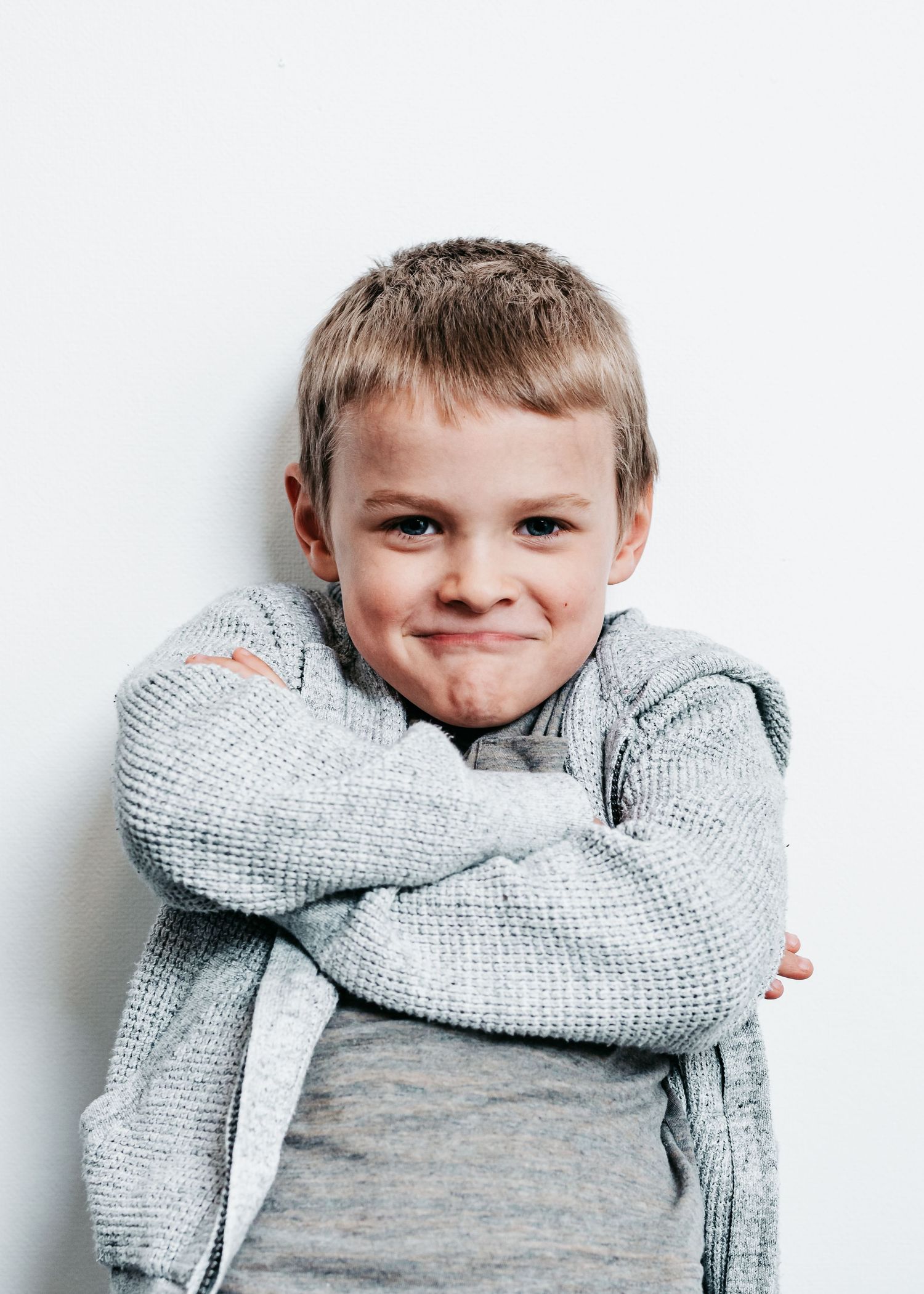 Four sequential photos showing child in gray sweater performing vampire dab pose against white background.