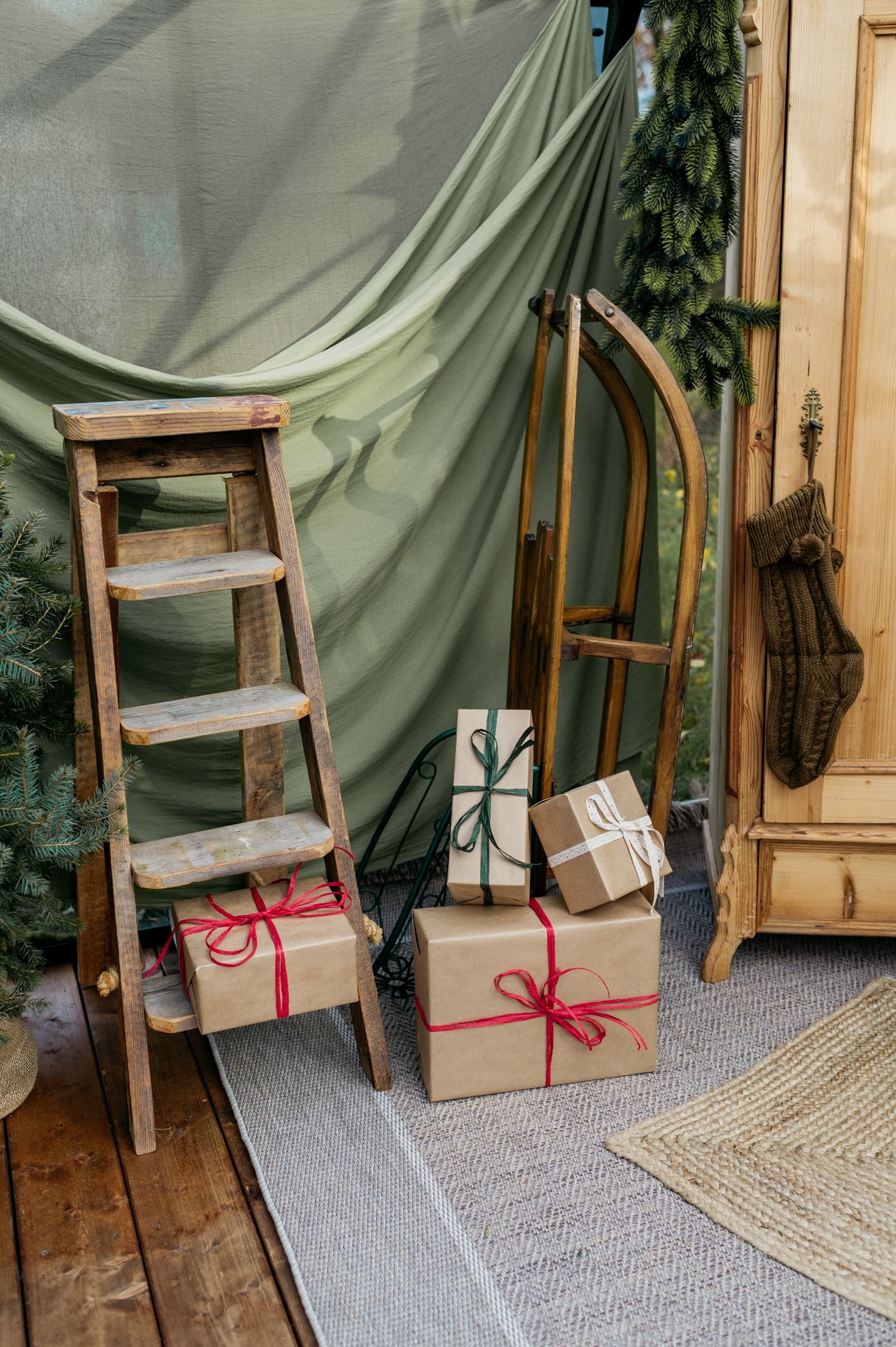 A series of five images showing brown paper wrapped packages with red ribbon against a green curtain backdrop.