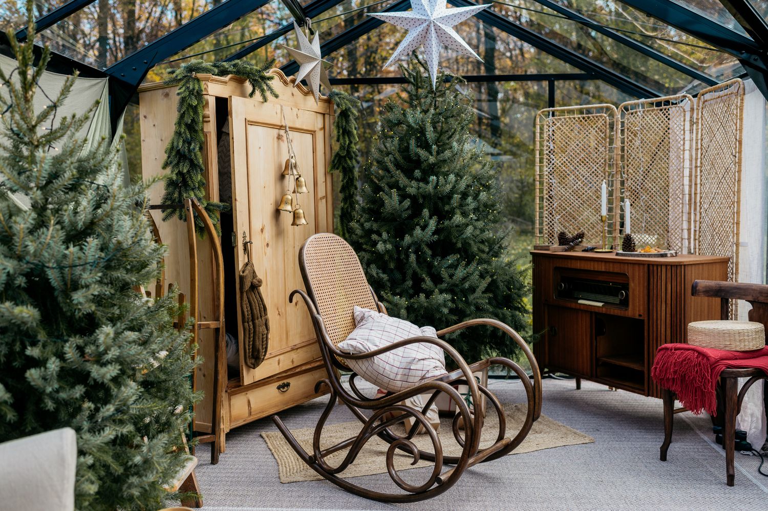 A cozy rustic cabin interior with a rocking chair and natural light streaming through windows.