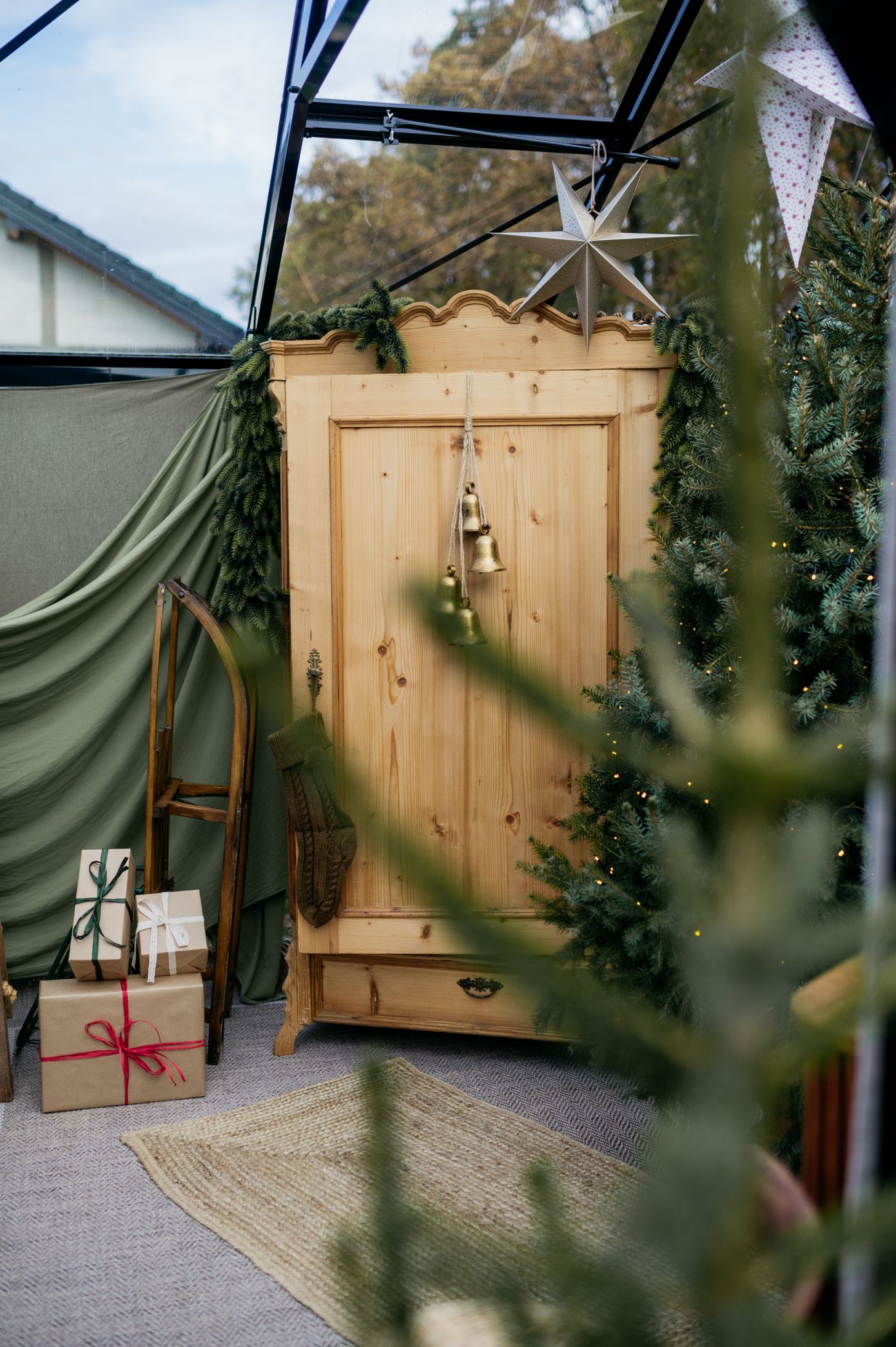 Pine wood armoire with natural finish and rustic design photographed in outdoor garden setting.