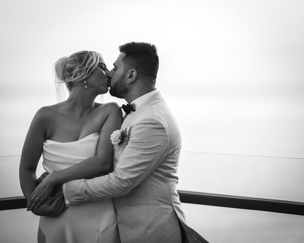 A black and white series of romantic couple photos showing tender kisses and intimate moments on their wedding day.