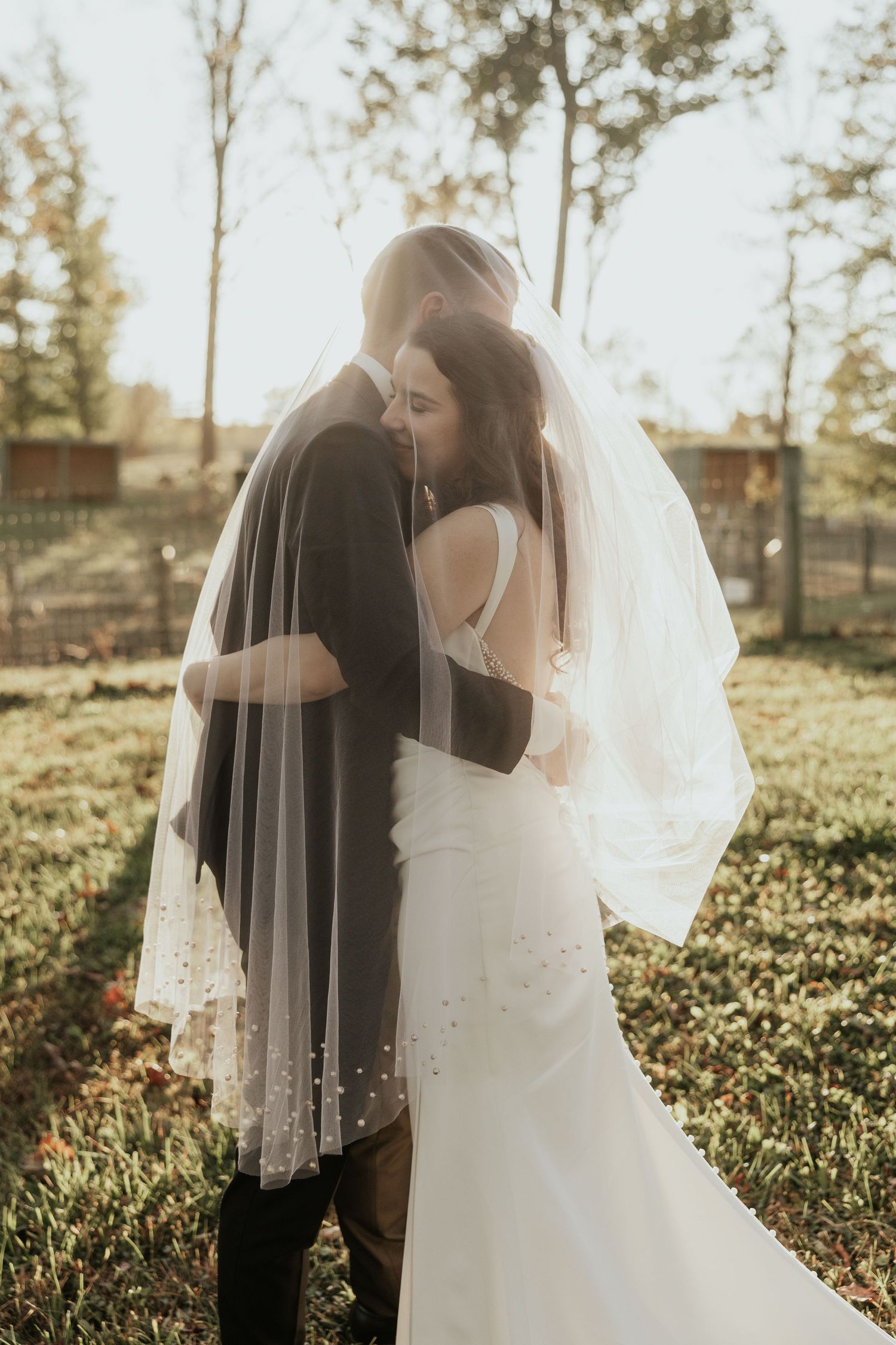 A tender wedding photography sequence captures a romantic moment between the couple in a golden sunlit garden setting.