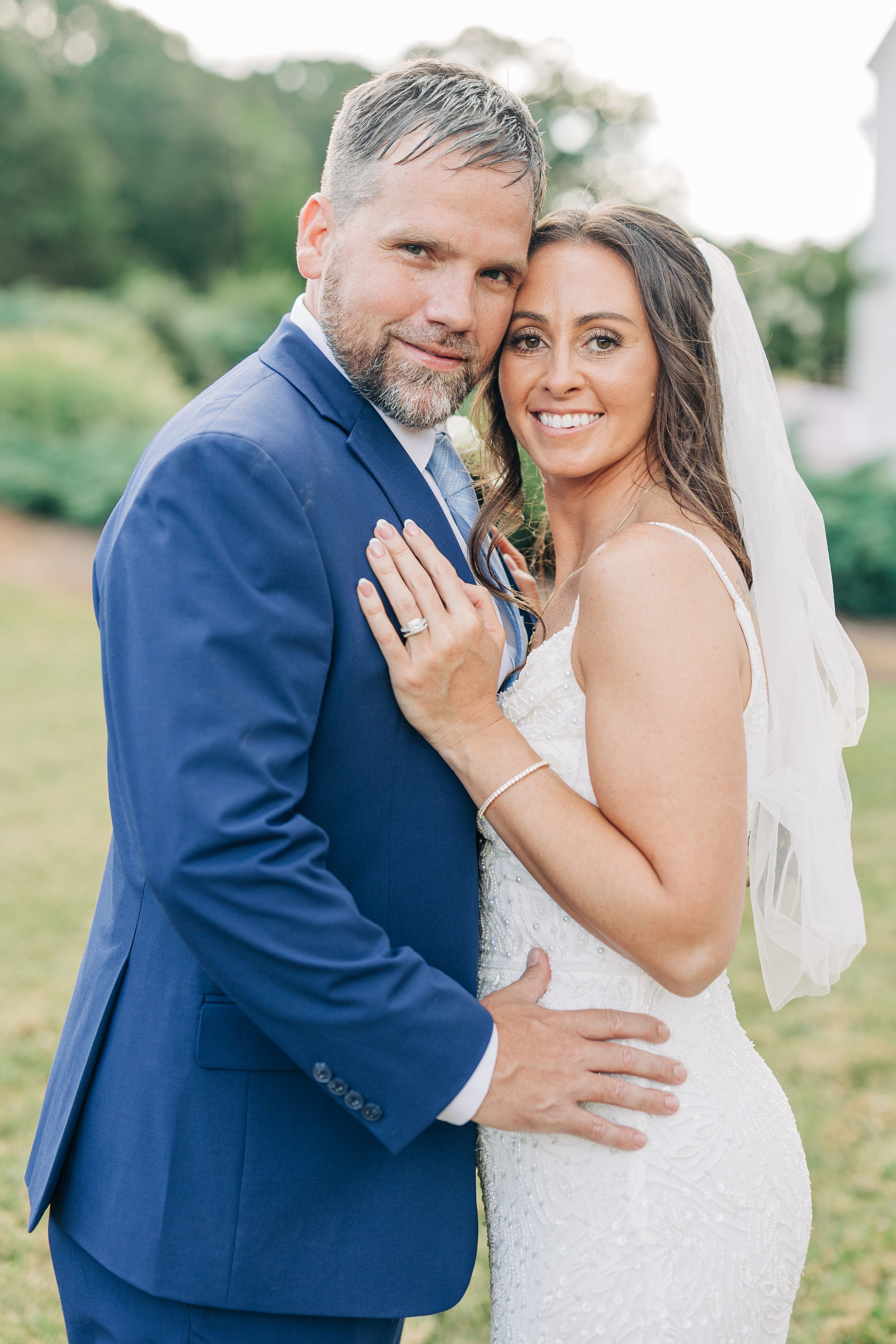 A romantic series of wedding portraits showing a couple in navy suit and white dress sharing intimate moments outdoors.