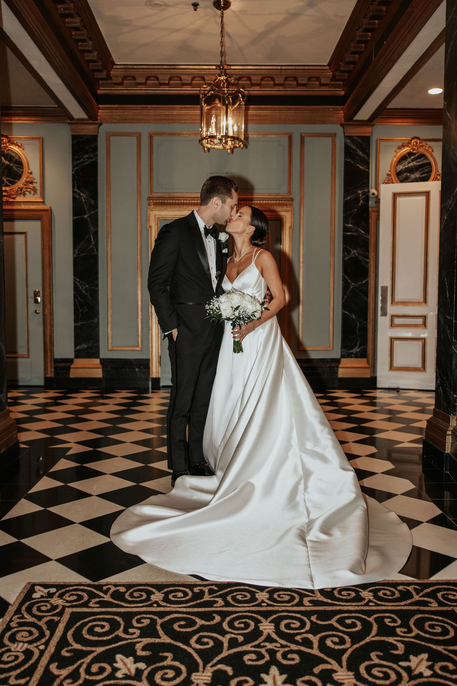 A romantic moment unfolds as newlyweds share their first dance during an elegant wedding reception.