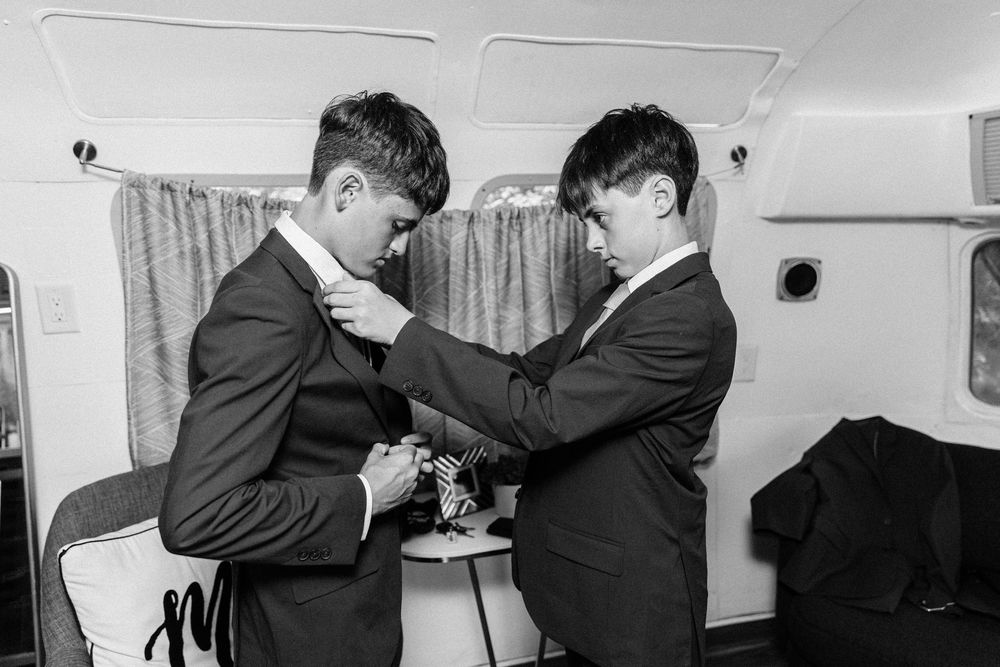 Several vintage black and white photos show two men in suits engaging in a physical altercation in an office setting.