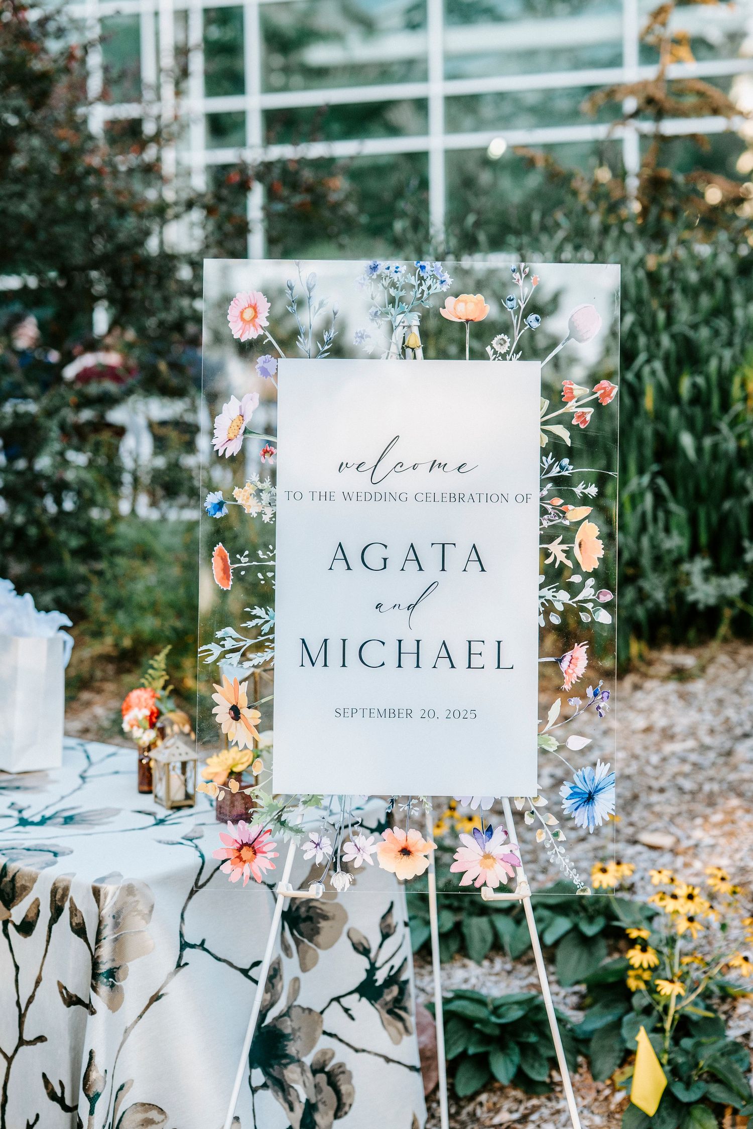 Elegant wedding welcome signs with floral decorations and the couple's names displayed at the venue.