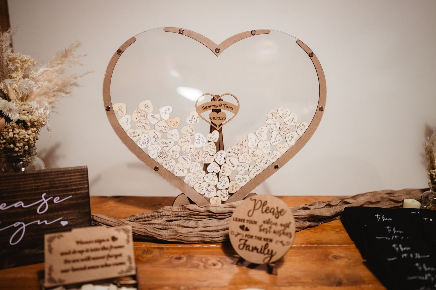Wedding table settings displayed under romantic heart-shaped lights in a rustic venue creating an intimate atmosphere.