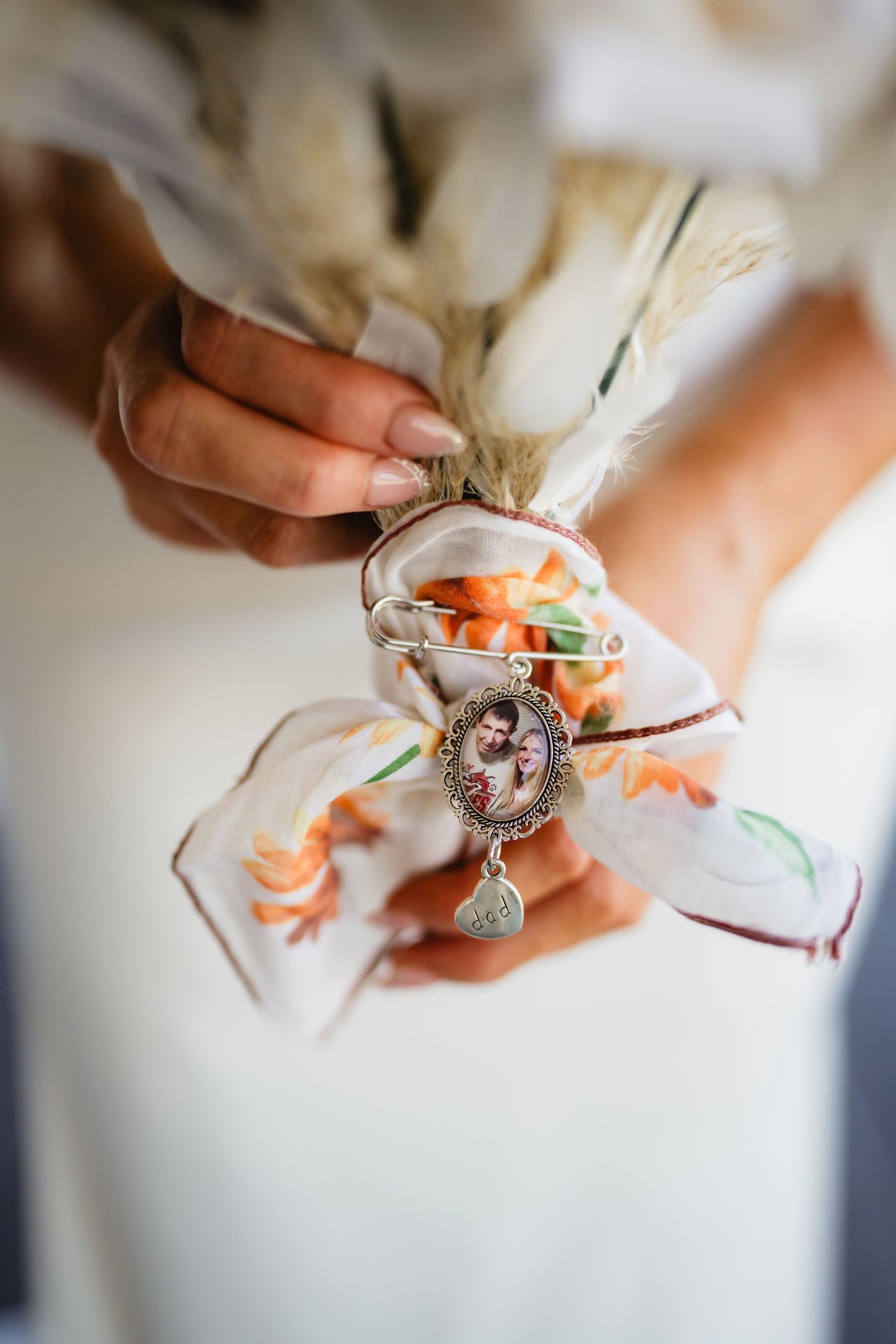 Close-up details of bridal jewelry and accessories being fastened in preparation for a wedding.