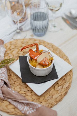 Appetizer dishes served on woven placemats at an elegant table setting.