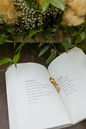 Open book with text pages decorated with delicate baby's breath flowers and greenery.