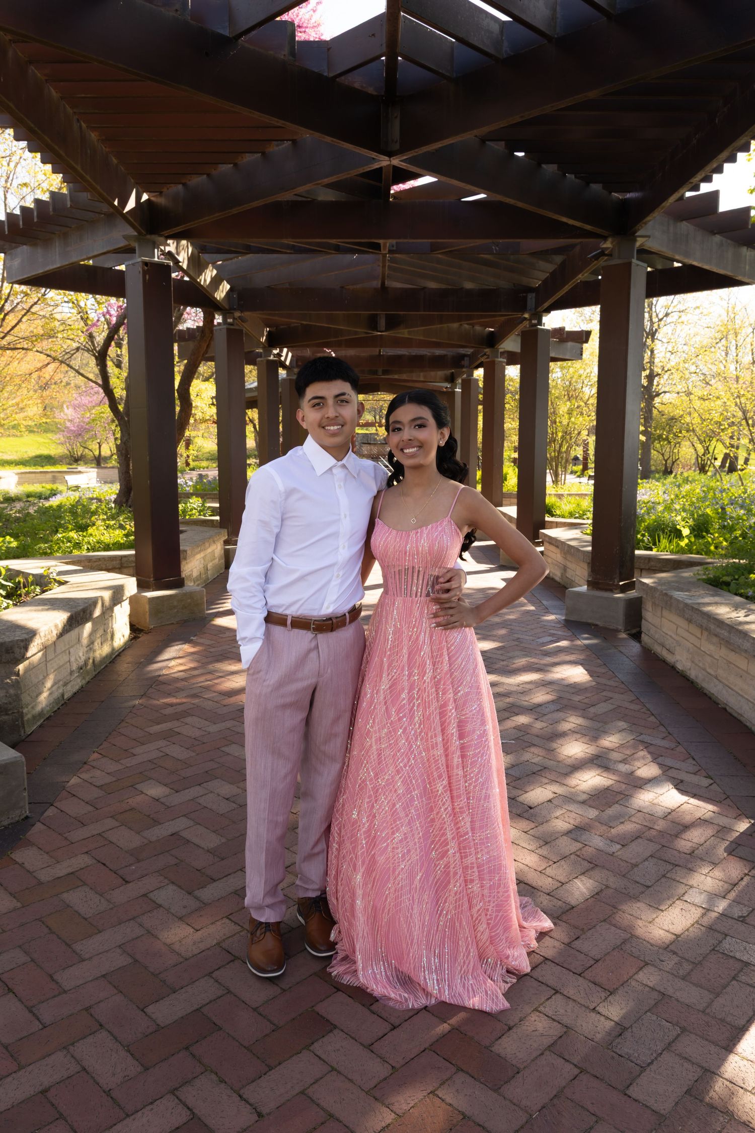 Sweet 16 girl in pink dress posing with her father at Independence Grove. Professional family event photography in Lake County by Alex T.