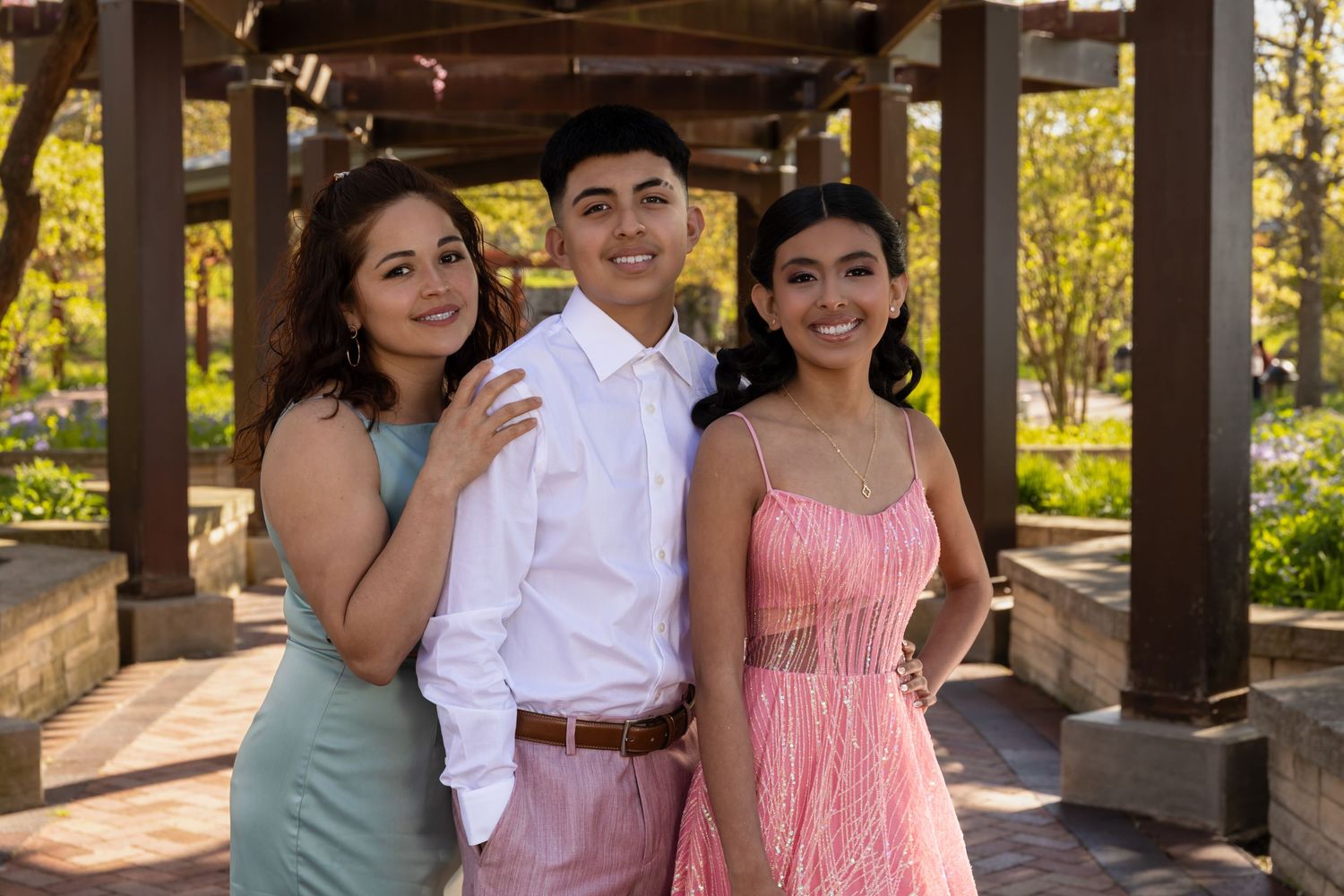 Sweet 16 portrait with siblings in a sun-drenched garden. Professional youth milestone and family photography in Waukegan by Alex T.