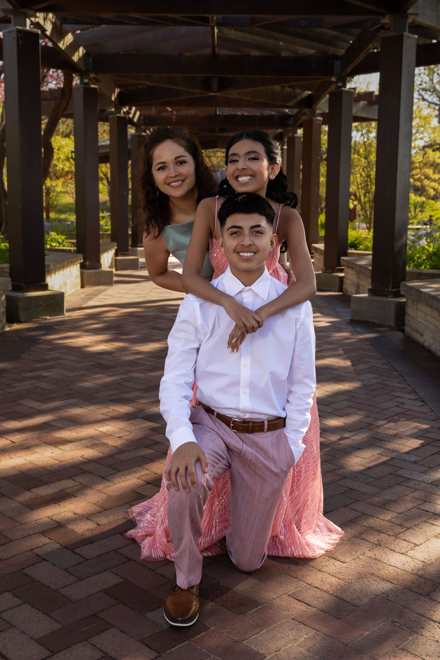 Playful family portrait with siblings in a scenic garden setting. Professional lifestyle and event photography in Lake County by Alex T.