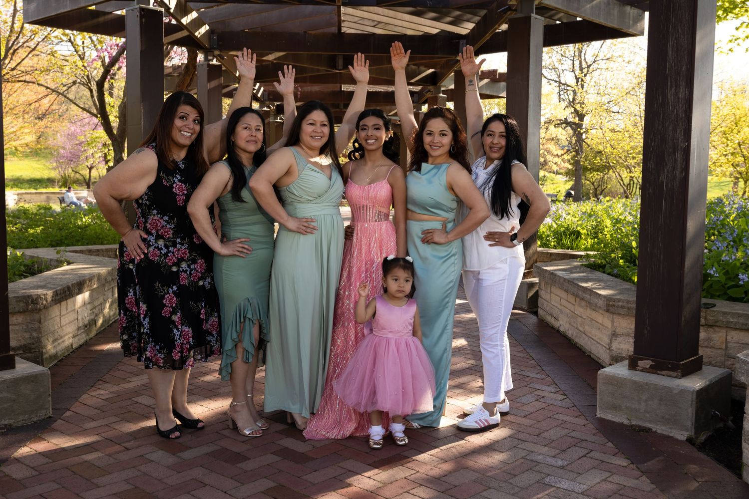 Quinceañera and her court of honor posing under a garden pergola. Professional XV group photography in Lake County by Alex T Photography.