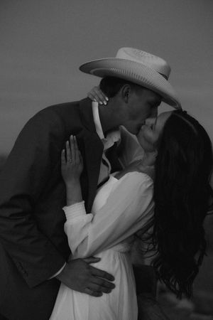 A romantic black and white photo series showing a couple embracing and kissing in dramatic silhouettes.