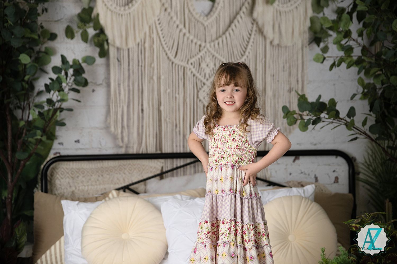 A series of photos showing a child in a floral dress playing on a bed with macrame wall decor and greenery.