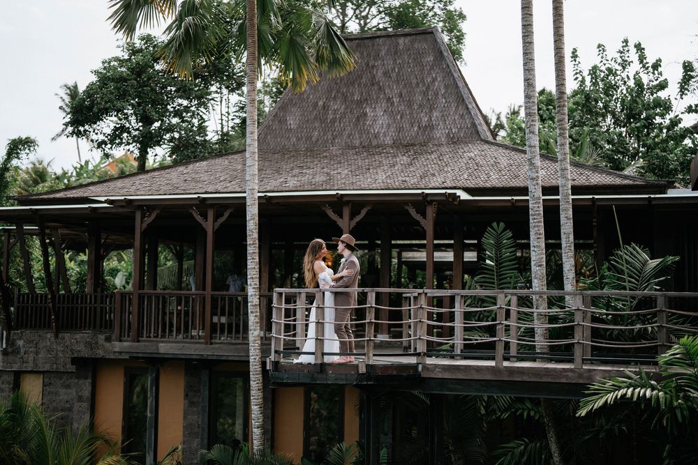 An aerial view of a tropical resort with thatched roof buildings and wooden walkways.